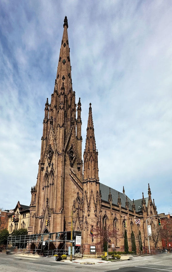 First & Franklin Presbyterian Church with its soaring spires into a high-cloudy blue sky